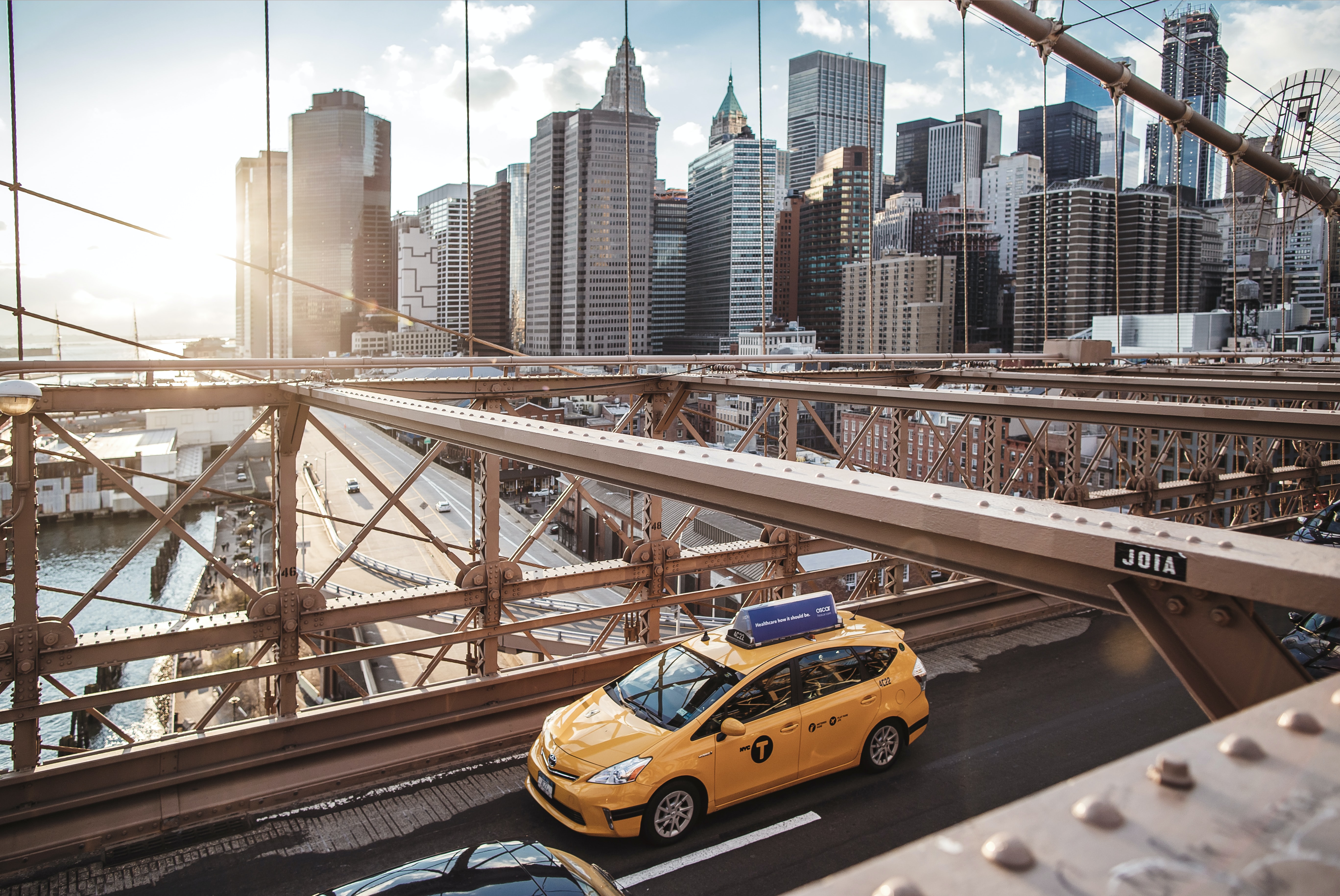 yellow taxi on bridge 