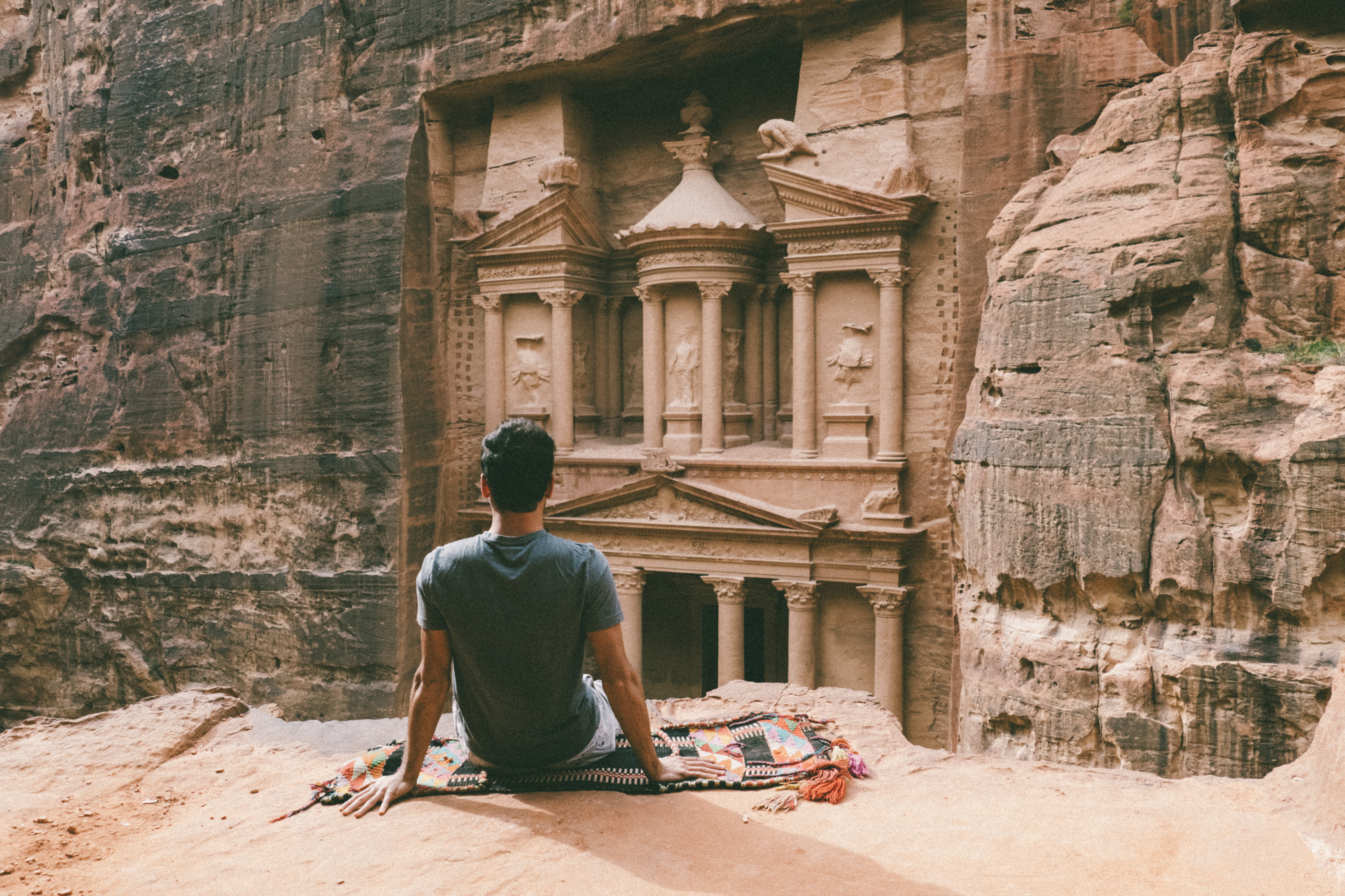 Person looking at historic rock facade