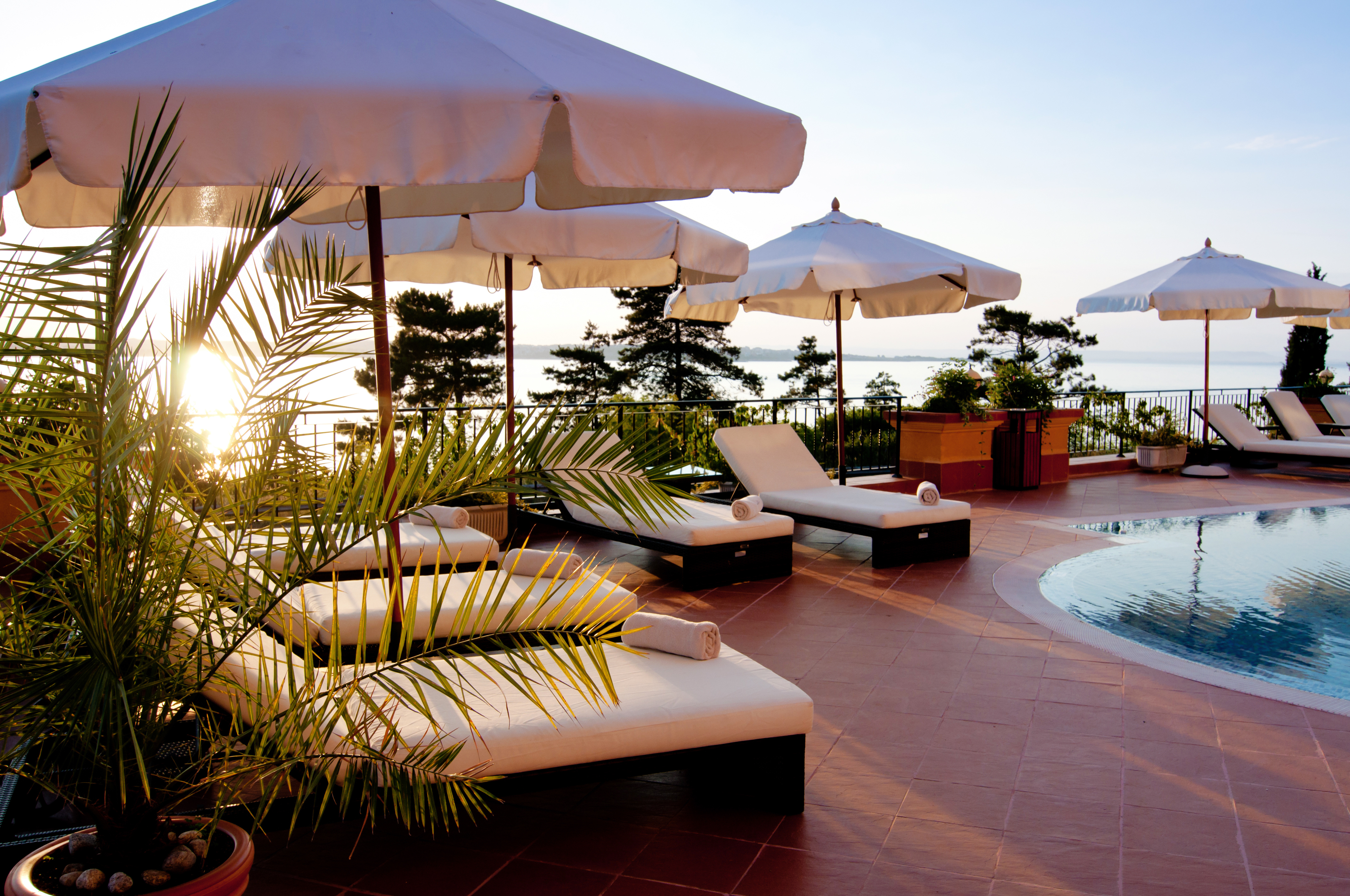 hotel pool with umbrellas and chairs