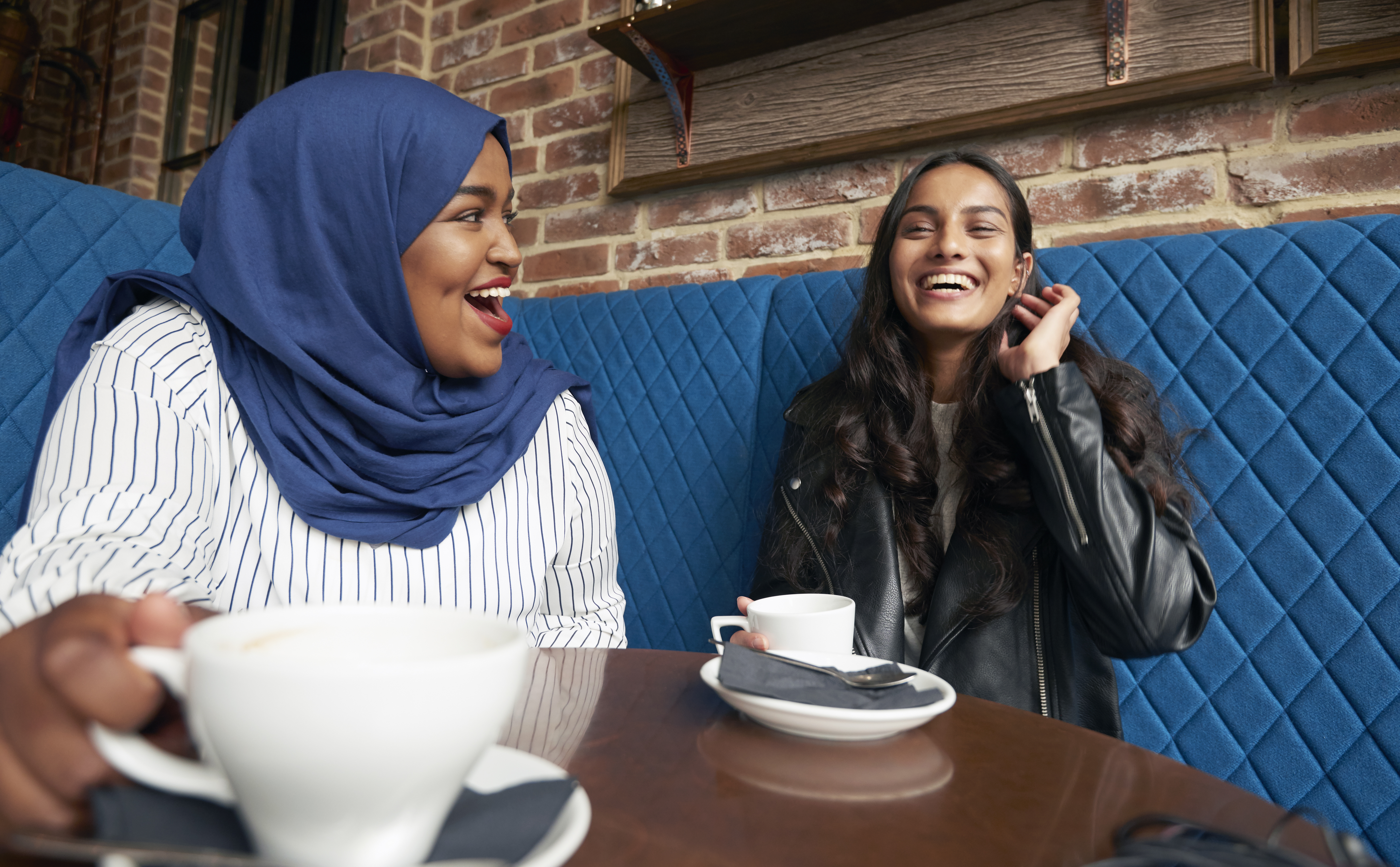 two people talking and enjoying coffee 