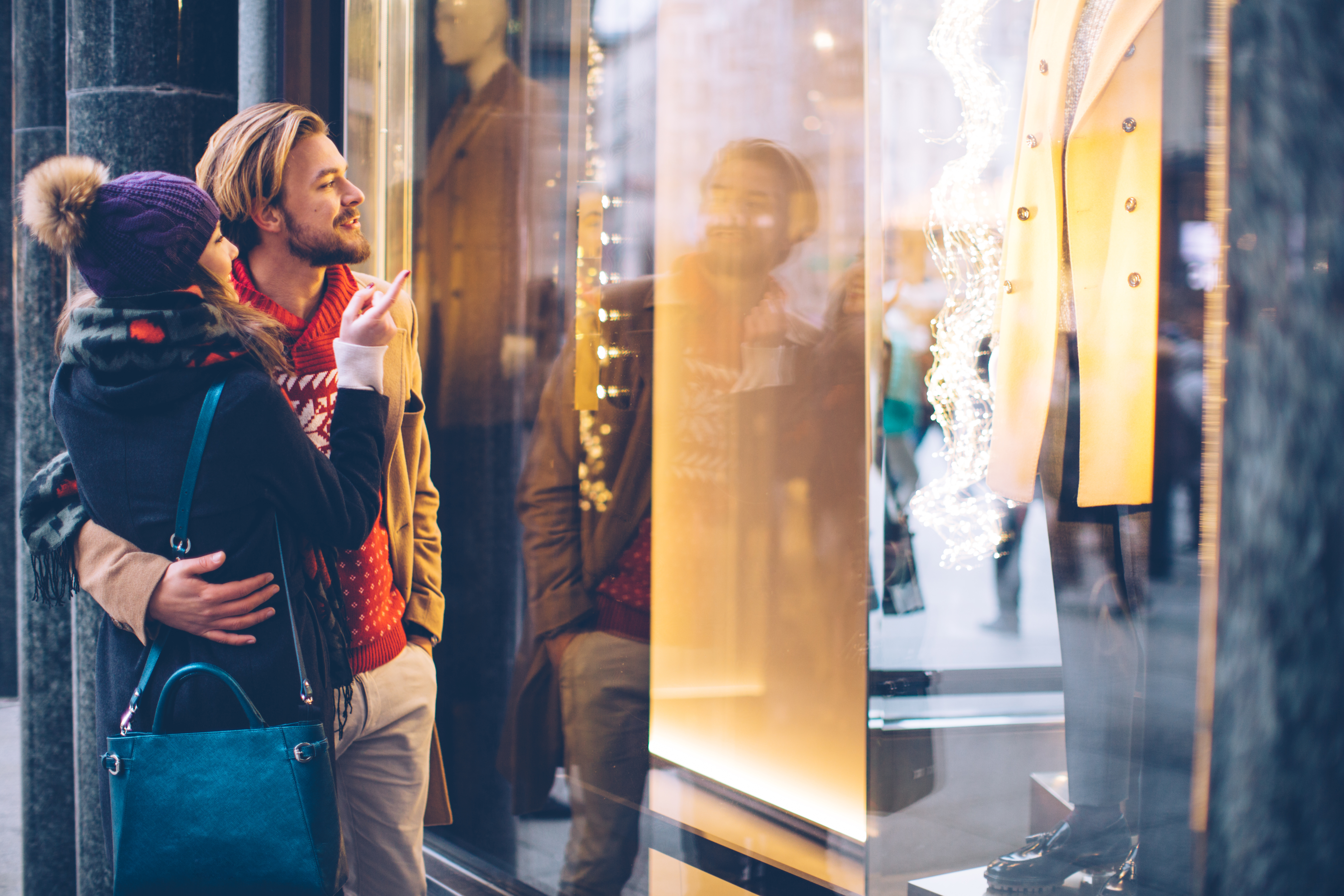 couple looking at holiday window display