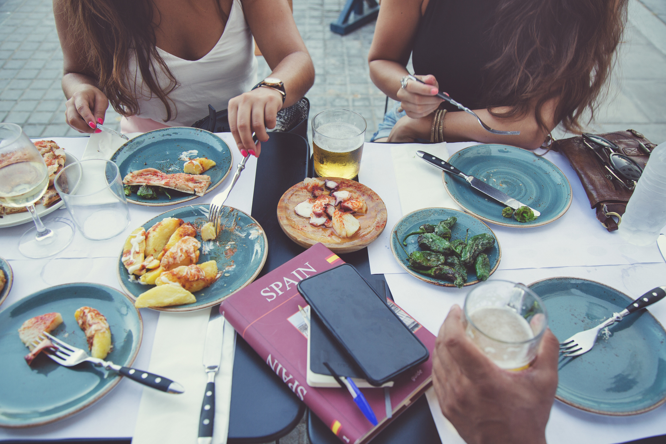 group of friends around a table with food