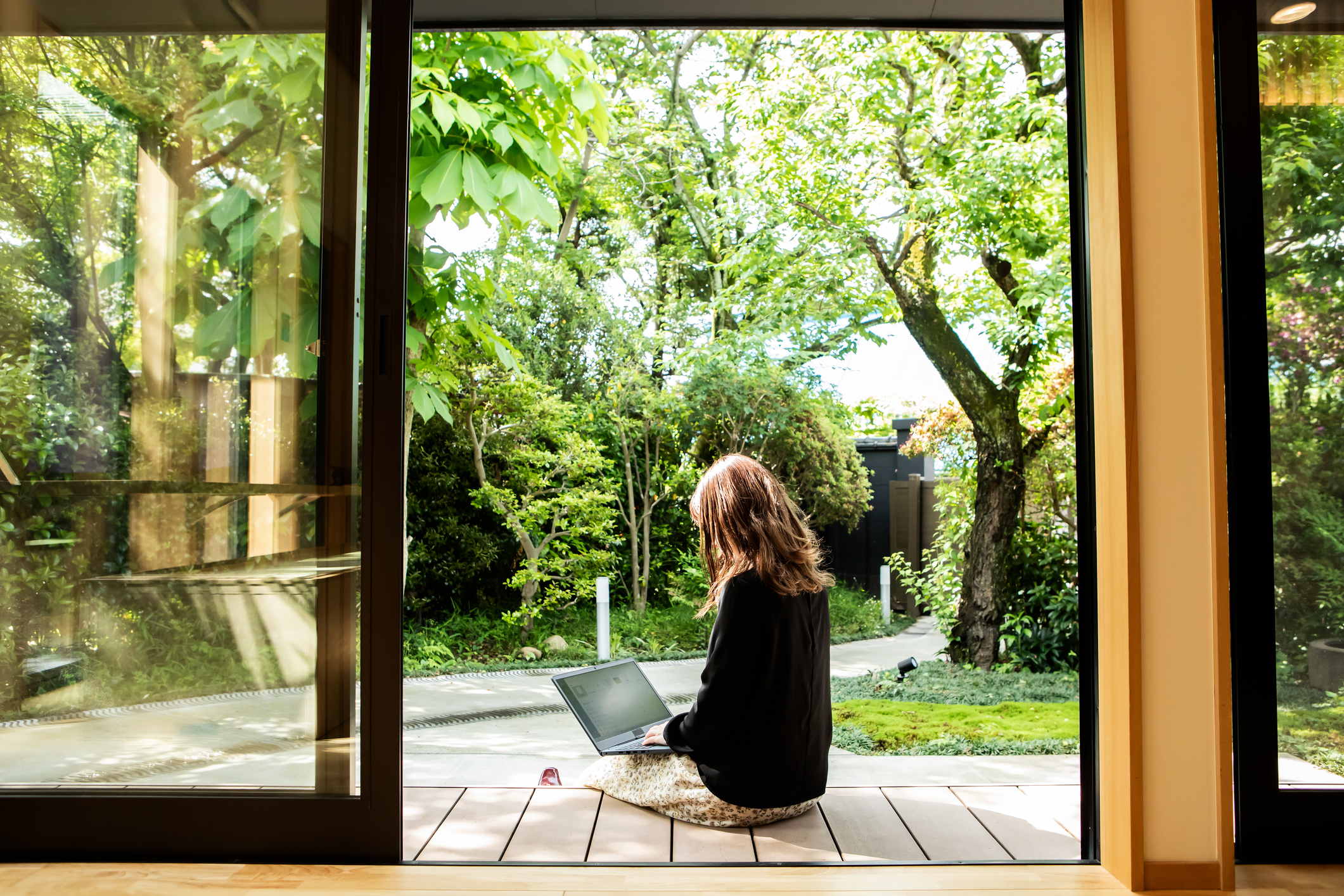 person sitting outside on laptop