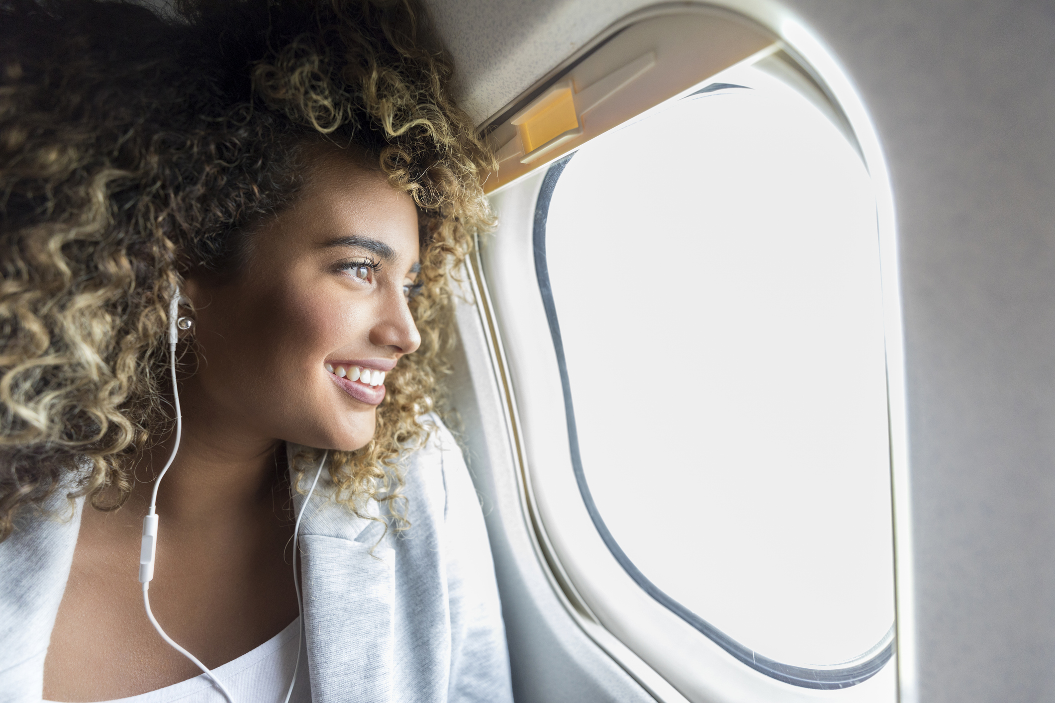 person looking out plane window