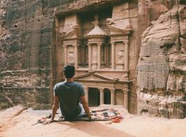 Person looking at historic rock facade