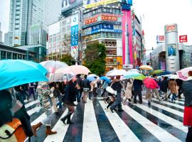 people crossing street in the rain